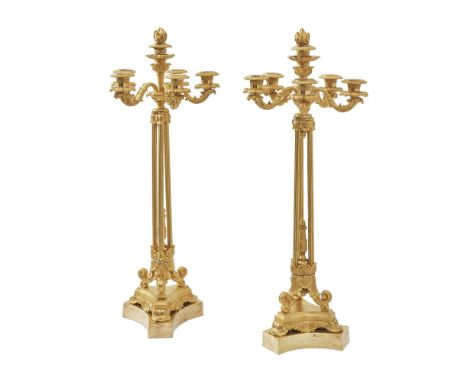 A PAIR OF CHARLES X ORMOLU SIX LIGHT CANDELABRA FRENCH, CIRCA 1835 With flame finials above unusual open cluster columns on t