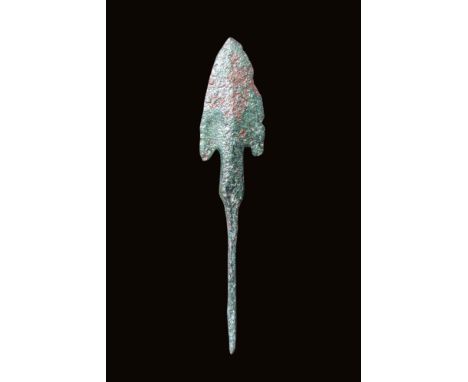 Ca. 2nd - 1st millennium BC.A cast bronze spearhead with a nicely shaped blade terminating in a sharp tip and exhibiting a mi