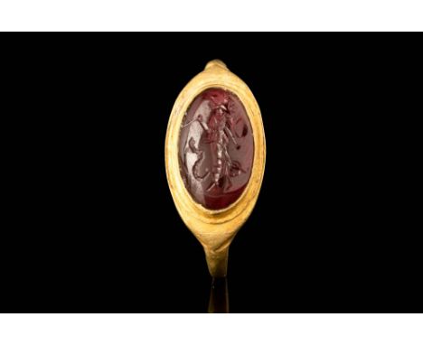 Ca. AD 1 - 100.A gold finger ring with a flat-section hoop that is slightly expanded at the shoulders. The almond-shaped beze