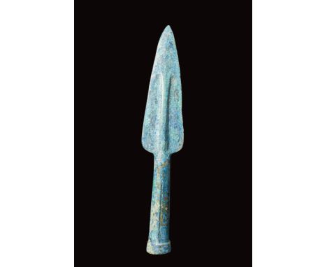 Ca. 400 - 300 BC.A cast bronze spearhead featuring a leaf-shaped blade with a thick midrib and a tubular, slightly flaring sh