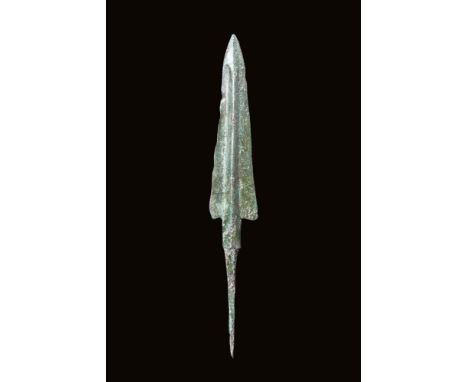 Ca. 2nd - 1st millennium BC.A cast bronze spearhead with a nicely shaped blade terminating in a sharp tip and exhibiting a mi