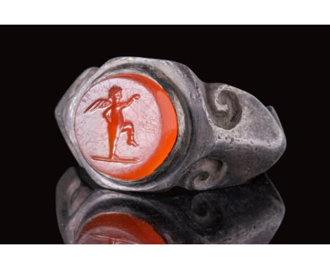 Ca. AD 100 - 200.A silver ring composed of a hoop with a carinated profile, dramatically expanding into wide shoulders that s