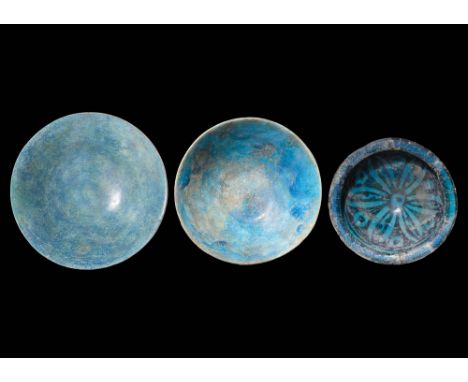 Ca. AD 1100 - 1300.A collection of Kashan terracotta bowls with an inverted conical body painted with in a blue pigmented und
