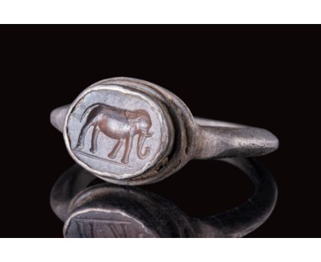 Ca. AD 100 - 200.A silver ring with a flat, slender hoop that transitions smoothly to a flat oval-shaped bezel. The bezel is 