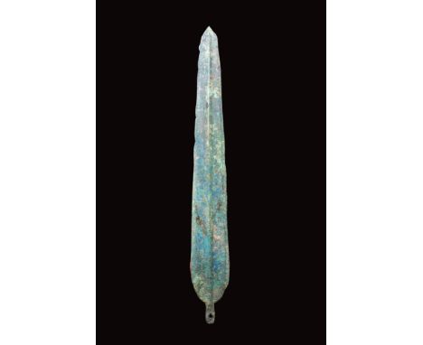 Ca. 2nd - 1st millennium BC.A cast bronze spearhead with an elongated, leaf-shaped blade that tapers to a sharp point. A prom