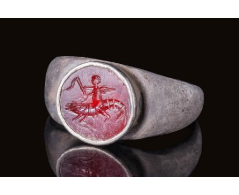 Ca. AD 1 - 300.A silver finger ring with a plain hoop and slightly expanded shoulders supporting a raised bezel cell. The bez