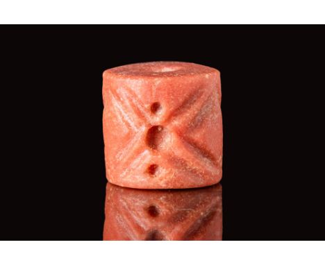 Ca. 3000 BC.A pink marble cylinder seal with the design consisting of a frieze of three motifs, each consisting of pairs of s