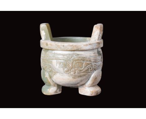 Ca. 19th century AD or later.A jade-carved censer featuring a deep, rounded bowl supported by three short, bent legs. The pro