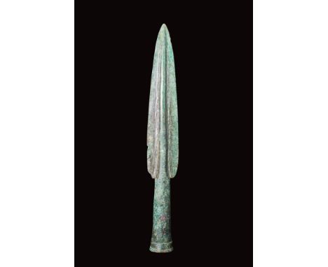 Ca. 400 - 300 BC.A cast bronze spearhead featuring a leaf-shaped blade with a thick midrib and a tubular, slightly flaring sh