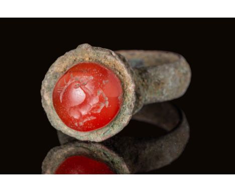 Ca. AD 300 - 600.A bronze ring composed of a round hoop with a smooth, rounded exterior. The ring is crowned with a prominent