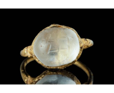 Ca. AD 700 - 800.An intaglio gold ring composed of a slender hoop with narrow shoulders. These shoulders are decorated with s