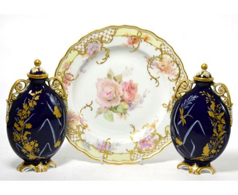 A Meissen cabinet plate painted with flowers (second) together with a pair of Worcester urns and covers (a.f.)