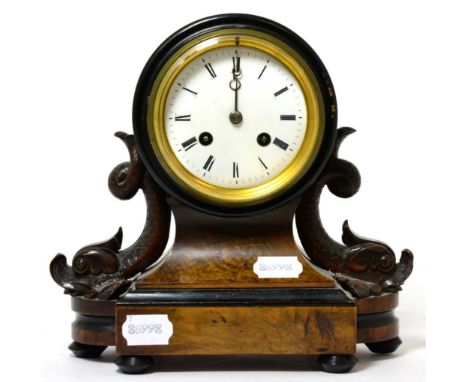 A Victorian striking mantel clock, enamel Roman dial, twin-train movement, carved dolphin supports on a plinth base