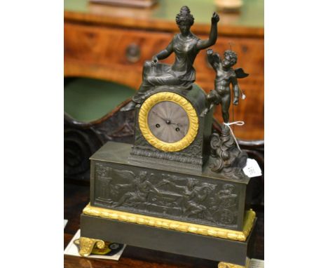 A French gilt metal striking mantel clock, case depicting a lady in robes with a winged cherubDial diameter is 2 1/2 inches w