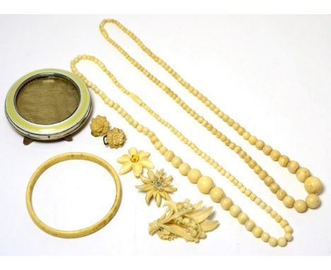 A quantity of early 20th century carved ivory jewellery and an enamel frame 