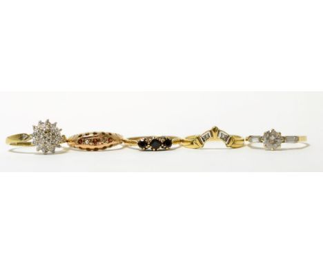 A 9ct gold diamond cluster ring, finger size L, a 9ct gold diamond wishbone ring, finger size R and three other 9ct gold gem 