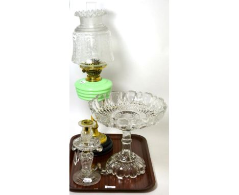 A Victorian oil lamp with green glass reservoir and etched glass shade, a glass lustre candlestick and a pressed glass pedest