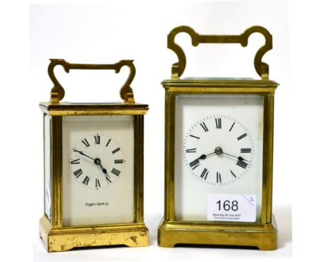 A brass carriage clock and a smaller similar timepiece 