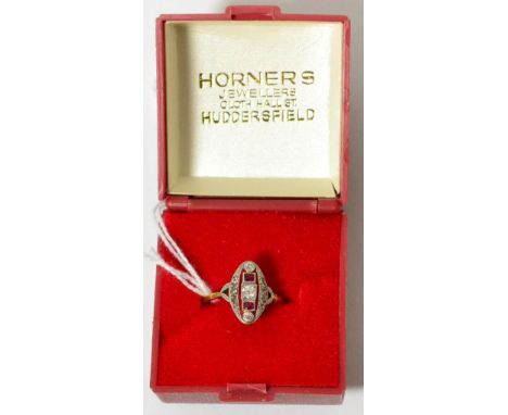 A diamond and ruby ring in a yellow metal mount Finger size P, 1.87g gross.