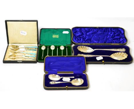 A Continental silver gilt and enamel set of six pickle forks; with three other cased sets 