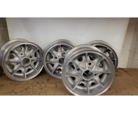 A set of four Dunlop light alloy wheels, 5x10", to suit a Mini. Also four unrelated centre caps marked "Minilight"