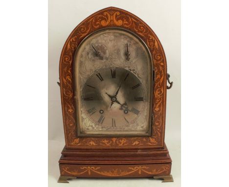 A 19th century arched mantel clock, the striking movement with silver dial and two subsidiary dials, the mahogany case with s