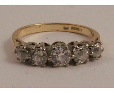 An 18 carat gold five stone diamond ring, the graduated old brilliant cuts totalling approximately 0.8 carats, finger size O,