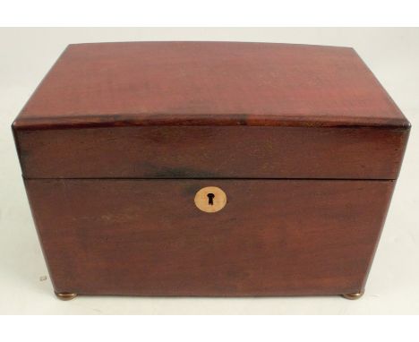 A mahogany tea caddy, of rectangular form, the interior fitted with a covered glass bowl and covered compartments, on oblate 