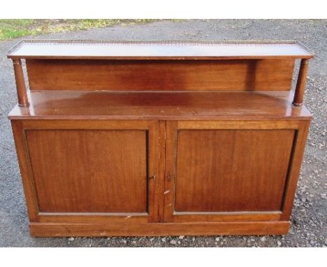 A mahogany cabinet, fitted with a shelf over with brass gallery supported by columns, the base fitted with a pair of cupboard