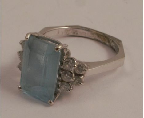 An aquamarine and diamond ring, the white mount stamped '18K', the step cut stone approximately 11.8mm by 7.8mm, by 4.9mm dee