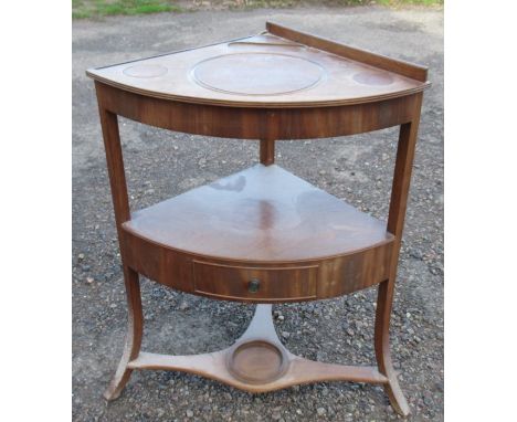 A 19th century mahogany corner washstand, fitted with a drawer to the middle section and a plant stand to the lower shelf, he