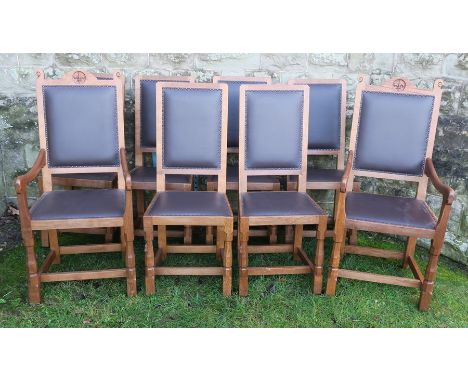 A set of eight Robert Mouseman Thompson oak dining chairs, comprising two carvers and six singles, the carvers carved with a 