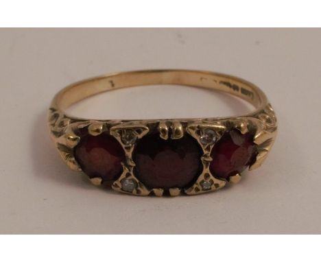 An amethyst and seed pearl cluster ring, together with a 9 carat gold three stone garnet ring