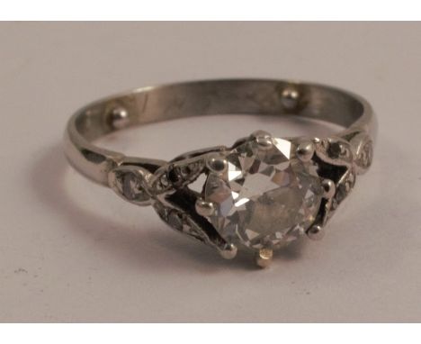 A platinum single stone diamond ring, the transitional cut stone of approximately 0.75 carats, calculated, with a trio of sin