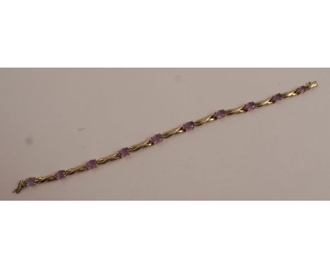 A 9 carat gold amethyst bracelet, the ten oval cuts alternating with figure of eight links, to a hidden box clasp, 5.7g gross