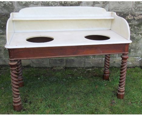 A Victorian walnut marble topped wash stand, with marble shelf to the gallery back and sides, with two wells, raised on a bas