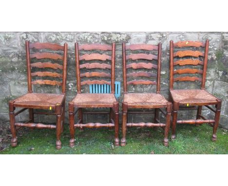 A set of four wavy ladder back North Country style dining chairs, with rush seats