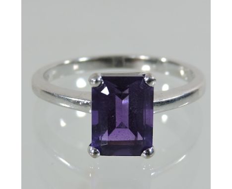 An 18 carat white gold baguette cut amethyst single stone ring