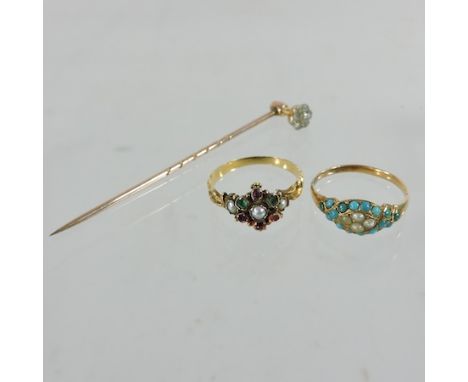 An early 20th century unmarked diamond set stick pin, together with a seed pearl and coral ring and a Victorian multi gem set