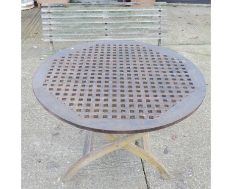 A wooden garden bench, on an iron base, 152cm, together with a folding teak garden table 