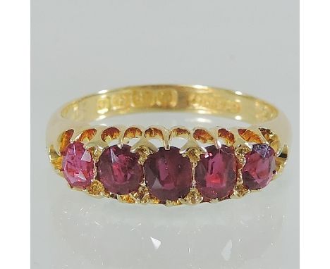 An 18 carat gold five stone ruby ring, boxed 