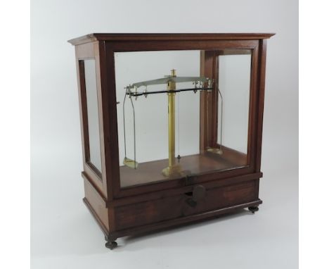 An early 20th century set of balance scales, in a glazed case, by W.A. Webb, London, 43cm tall, together with another set of 