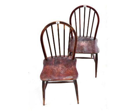 ERCOL; a set of three stained comb back chairs raised on turned stretchered supports (3). CONDITION REPORT These chairs have 