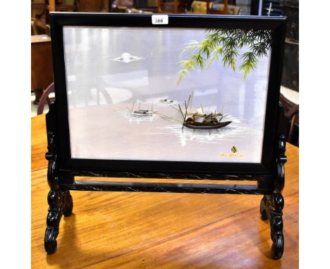 A modern Oriental black lacquered table screen with embroidered silk panel depicting fishing boats on calm lake at sunset, sa