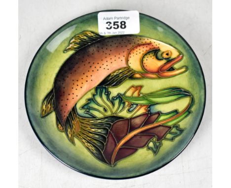 WALTER MOORCROFT; a small circular dish decorated with a leaping salmon on a green ground, width 15.5cm, silver strike throug