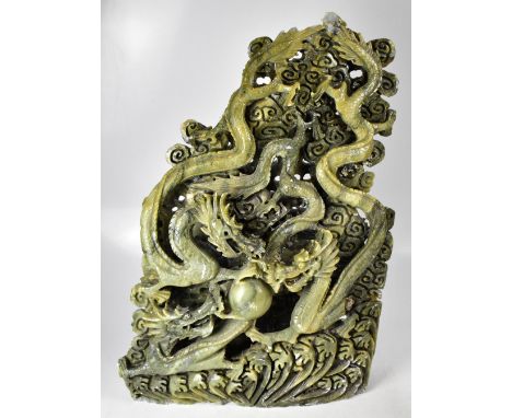 An early 20th century large impressively carved jade green hardstone carving depicting three water dragons chasing the Flamin