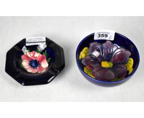 MOORCROFT; a small blue ground 'Anemone' pattern shallow bowl with small foot rim, height 5cm, diameter 11cm, together with a