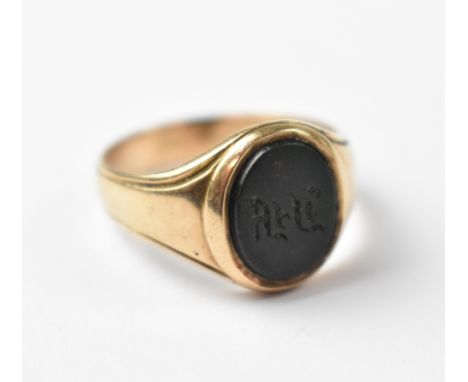 A 9ct gold gentlemen's signet ring with central oval bloodstone, carved with initials, size R, approx 4.9g.