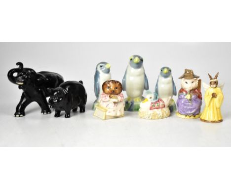 Three Wade penguin decanters, a black pottery elephant with trunk raised, numbered 815A, a black gloss Sylvac pottery pig mon
