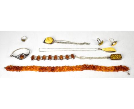 Various items of modern silver amber jewellery to include two yellow pendants and chains, similar silver ring, two green inse